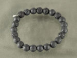 Top view of 8mm round Lava Quartz bracelet isolated on grey background