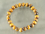 Angled view of shiny Tiger's Eye beads showing natural fiber structure