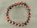 Top view of Red Tiger's Eye motivation bracelet isolated on grey background