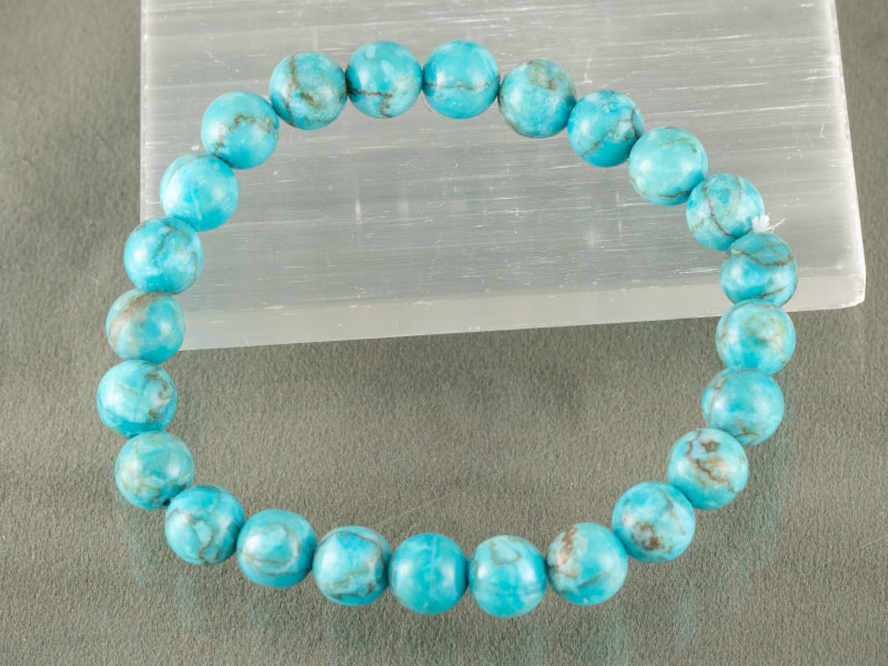 Turquoise Firoza Bracelet (Natural Quartz) – Certified 3 Turquoise healing crystal bracelet charging on white selenite plate