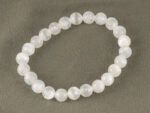 Top view of 8mm round Selenite gemstone bracelet isolated on grey background