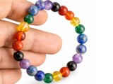 7 Chakra bracelet held in hand showing multicolor 8mm beads