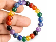 7 Chakra bracelet held in hand showing multicolor 8mm beads