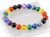 7 Chakra gemstone bead bracelet displayed on selenite plate (8mm beads)