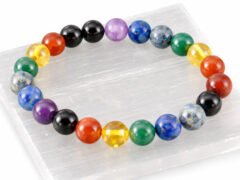 7 Chakra gemstone bead bracelet displayed on selenite plate (8mm beads)