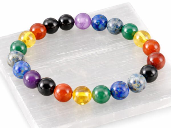 7 Chakra gemstone bead bracelet displayed on selenite plate (8mm beads)