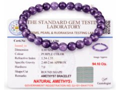 Amethyst bracelet placed over gem testing certificate showing 8mm beads