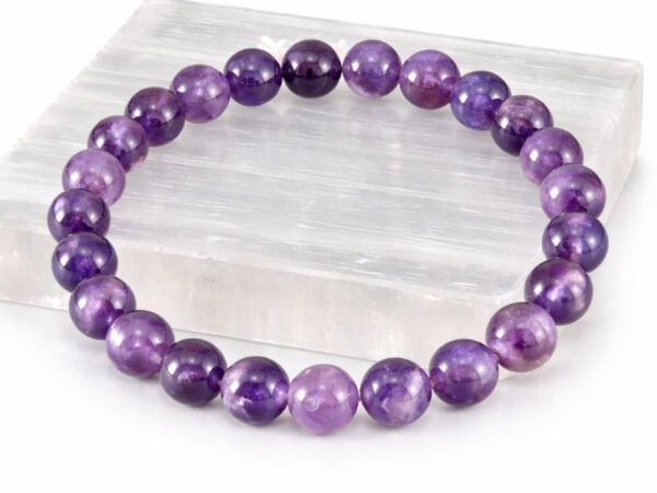 Amethyst gemstone bracelet displayed on selenite plate