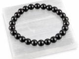 Black Obsidian gemstone bracelet displayed on selenite plate