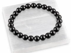 Black Obsidian gemstone bracelet displayed on selenite plate