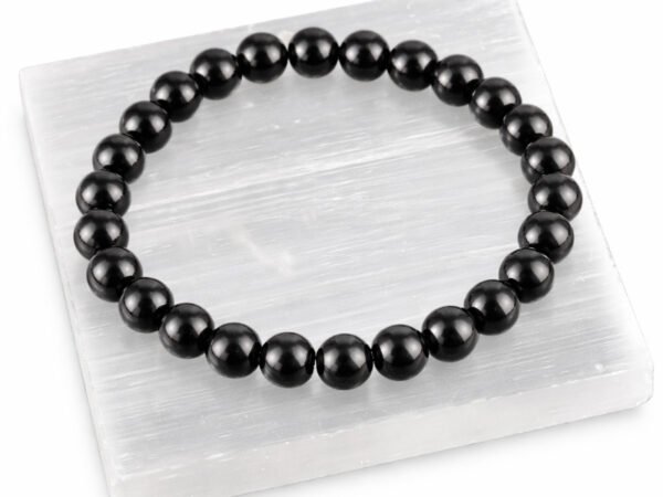 Black Obsidian gemstone bracelet displayed on selenite plate