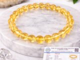 Natural Citrine bracelet displayed with certificate on marble surface