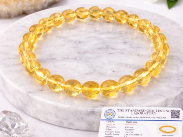 Natural Citrine bracelet displayed with certificate on marble surface