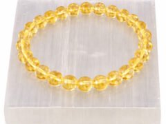 Citrine gemstone bracelet displayed on selenite plate