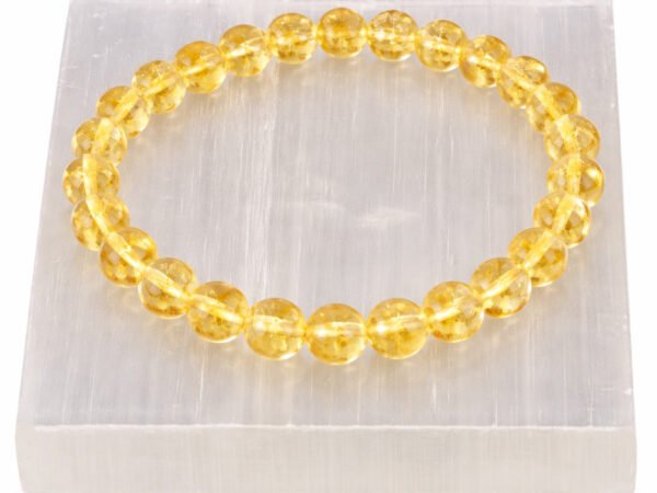 Citrine gemstone bracelet displayed on selenite plate