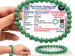 Green Aventurine bracelet held in hand with lab certificate for size reference