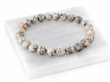 Natural Grey Jasper bead bracelet angled display on selenite plate
