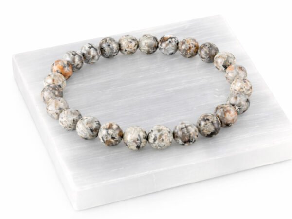 Natural Grey Jasper bead bracelet angled display on selenite plate