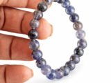 Iolite Neeli bracelet held in hand showing bead size and color