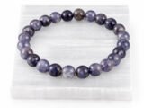 Iolite Neeli gemstone bracelet displayed on selenite plate