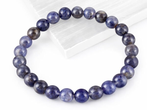Natural Iolite Neeli bead bracelet angled display on selenite plate