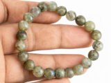 Labradorite bracelet held in hand showing bead size and color