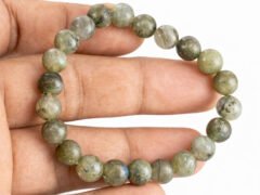 Labradorite bracelet held in hand showing bead size and color