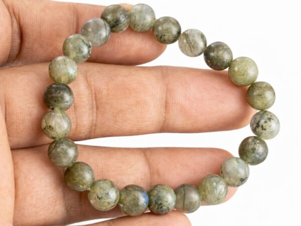 Labradorite bracelet held in hand showing bead size and color