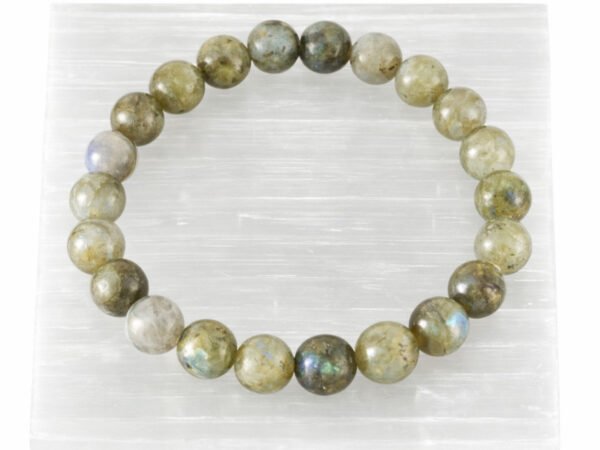 Labradorite gemstone bracelet displayed on selenite plate