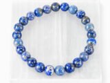 Natural Lapis Lazuli bead bracelet displayed on selenite plate