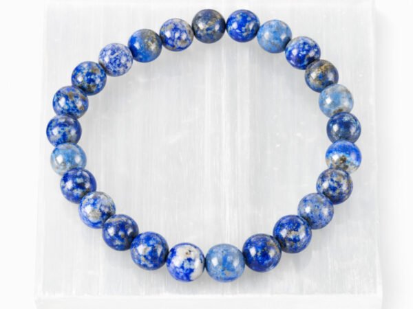Natural Lapis Lazuli bead bracelet displayed on selenite plate