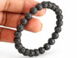 Lava Quartz diffuser bracelet held in hand showing bead size and texture