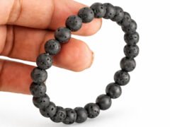 Lava Quartz diffuser bracelet held in hand showing bead size and texture