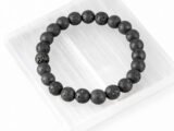 Lava Quartz black bead bracelet displayed on selenite plate