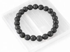 Lava Quartz black bead bracelet displayed on selenite plate