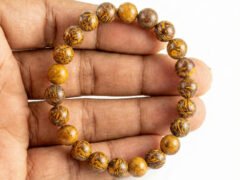 Mahemariyam calligraphy stone bracelet held in hand showing bead size and patterns