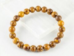 Mahemariyam calligraphy stone bracelet angled display on selenite plate