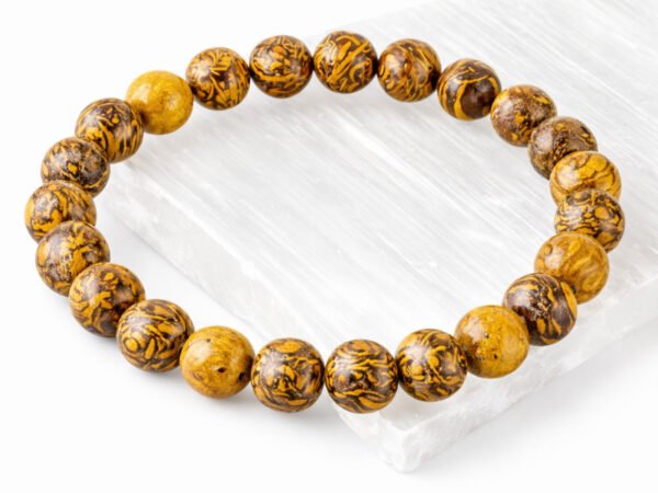 Mahemariyam calligraphy stone bead bracelet displayed on selenite plate