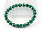 Authentic Malachite stone bracelet resting on a white display plate.