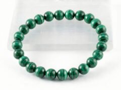 Authentic Malachite stone bracelet resting on a white display plate.