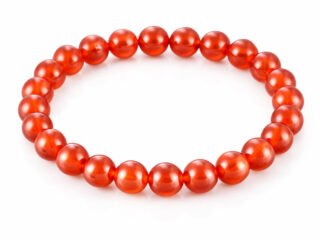 Natural Red Quartz 8mm round bead bracelet isolated on a plain white background.