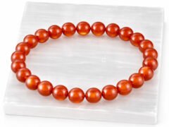 Authentic natural Red Quartz gemstone bracelet resting flat on a white textured display plate.