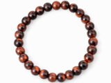 Natural Red Tiger Eye 8mm round bead bracelet isolated on a plain white background.
