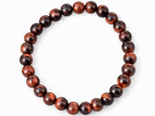 Natural Red Tiger Eye 8mm round bead bracelet isolated on a plain white background.