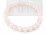 Close-up of an authentic natural Rose Quartz stone bracelet resting partially on a white rectangular display plate.