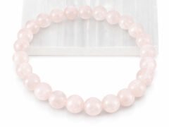 Close-up of an authentic natural Rose Quartz stone bracelet resting partially on a white rectangular display plate.