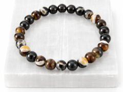 Authentic natural Sulemani Hakik gemstone bracelet resting flat on a white textured square display plate.