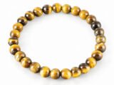 Natural yellow Tiger Eye 8mm round bead bracelet isolated on a plain white background.