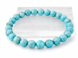Authentic Turquoise Firoza gemstone bracelet resting flat on a white square display plate.
