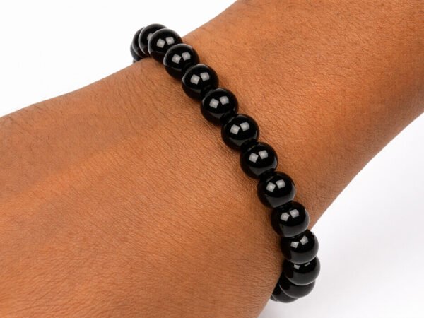 Natural Black Quartz gemstone bracelet being worn on a wrist, showing scale and comfortable fit.